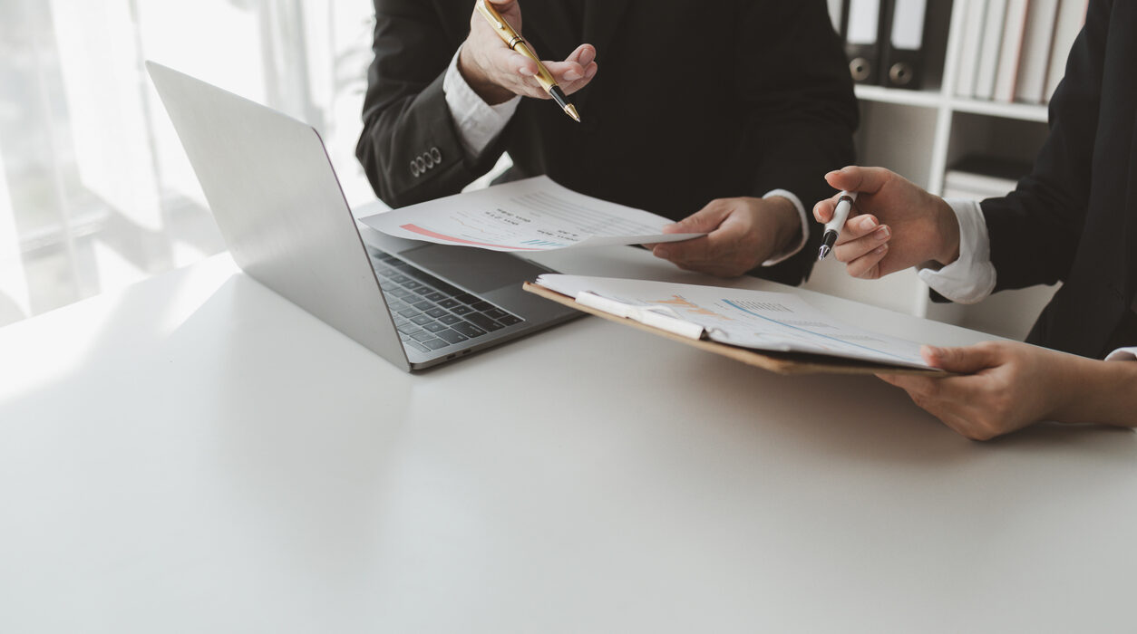 businessmen working together to calculate income