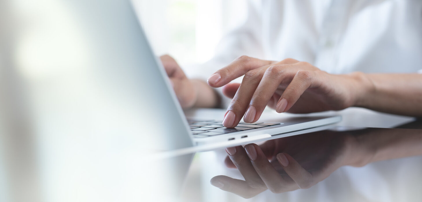 business woman hand typing on laptop computer keyboard