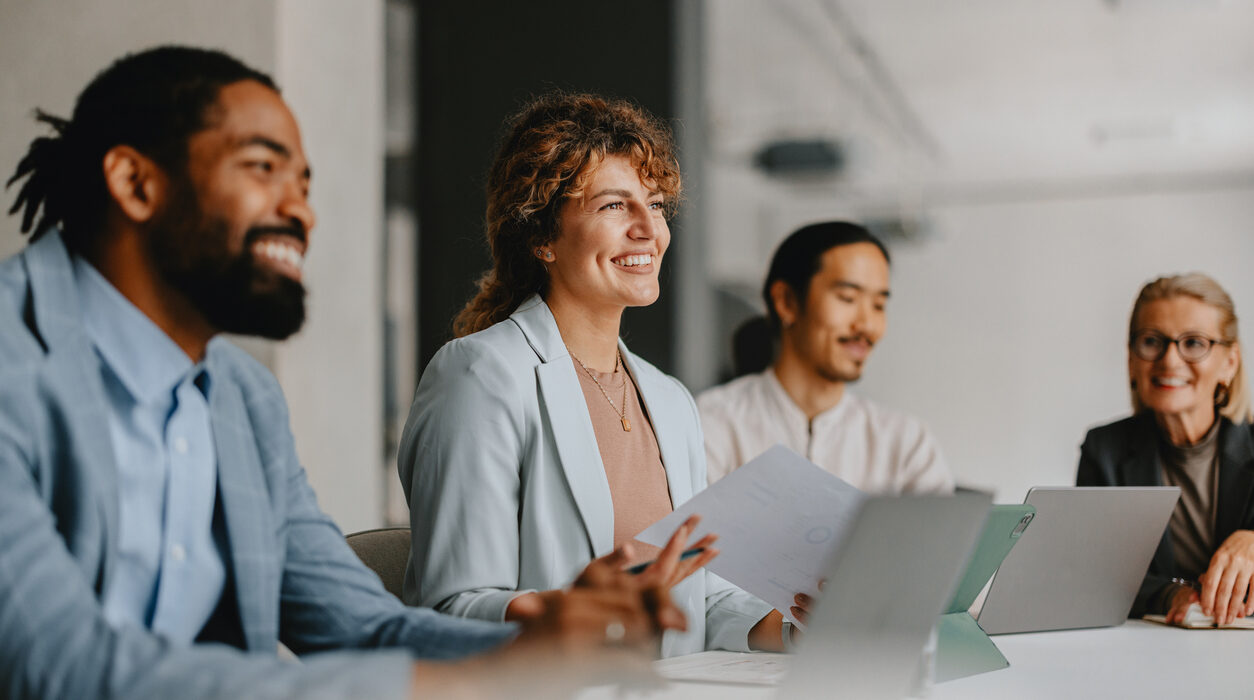 group of smiling colleagues in a business meeting