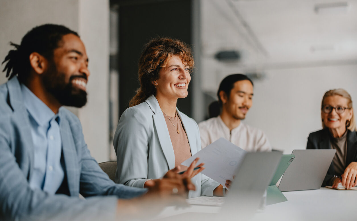 group of smiling colleagues in a business meeting