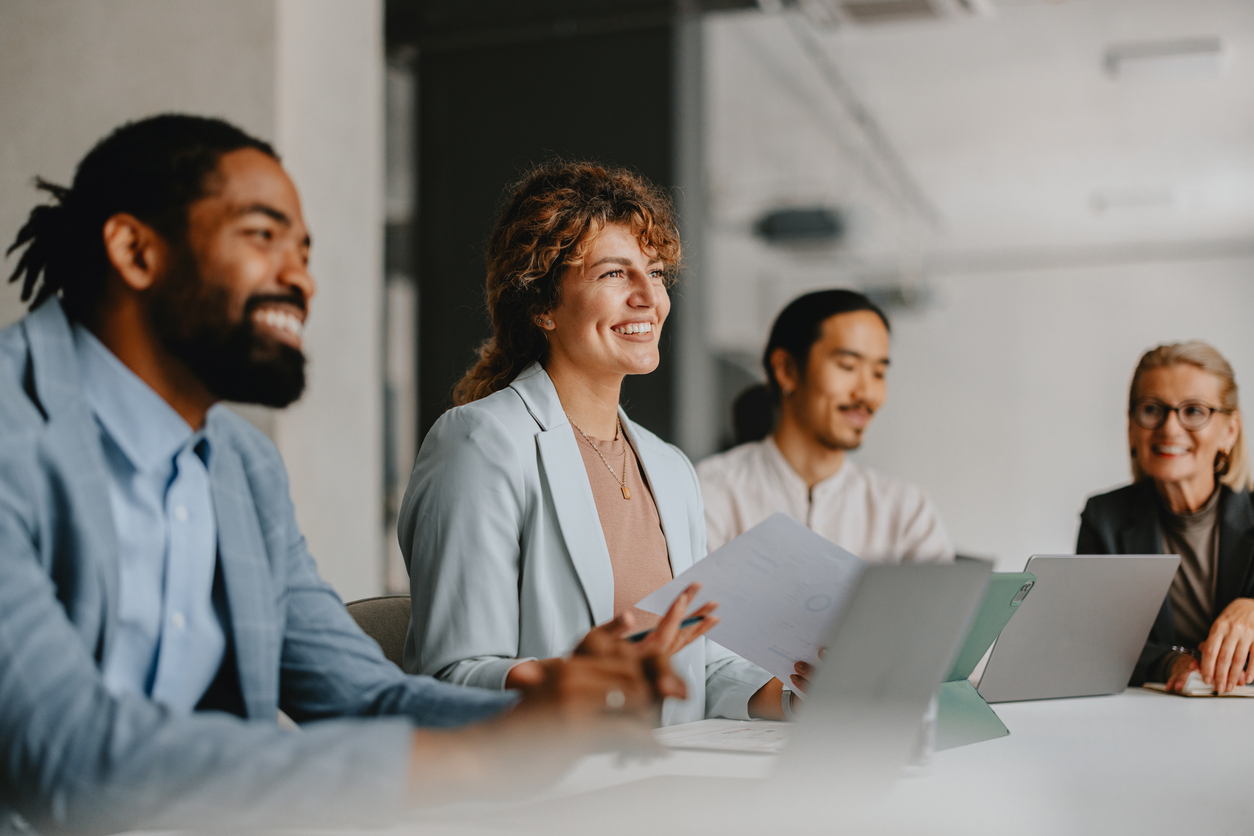 group of smiling colleagues in a business meeting