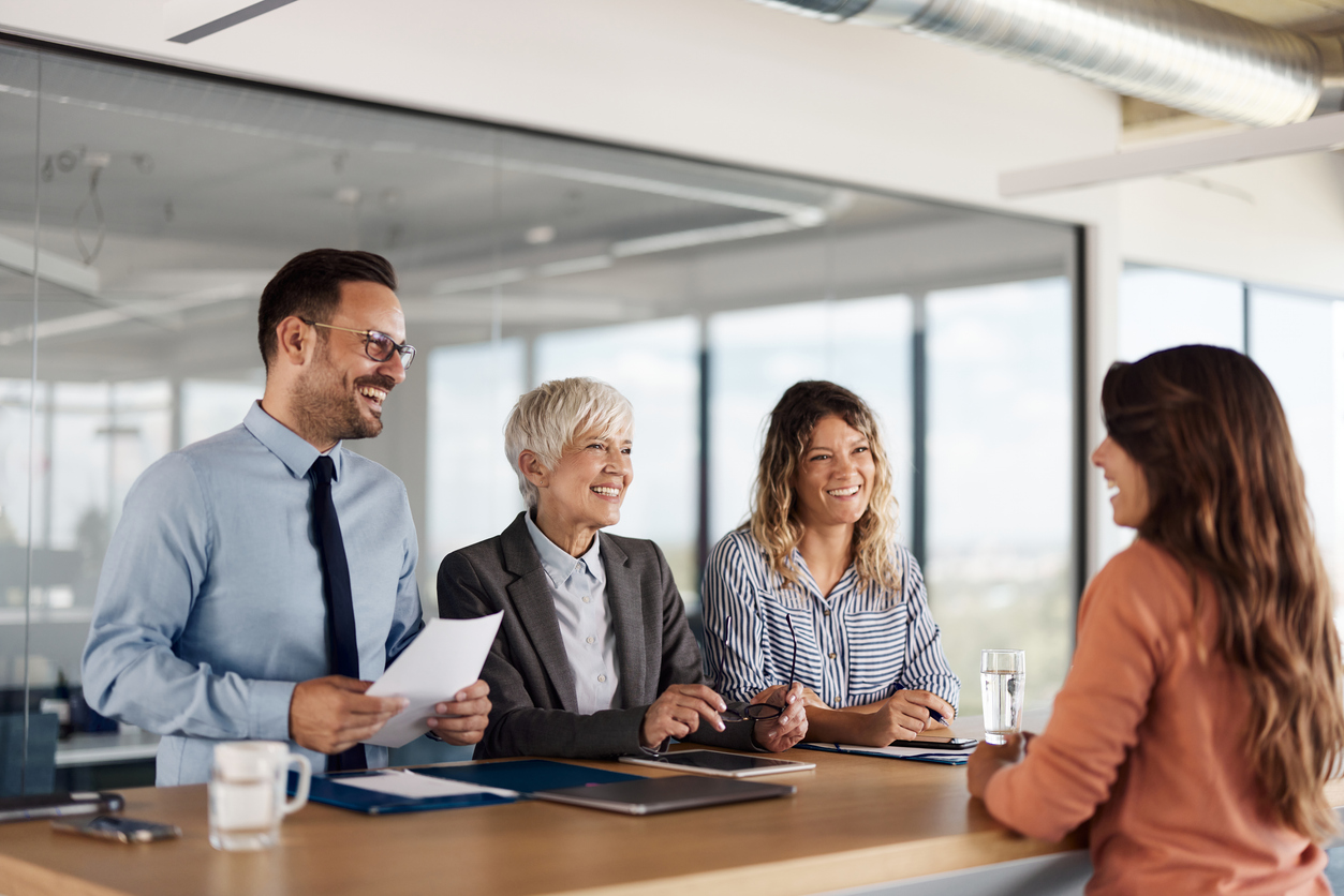 human resource team having a job interview with a female candidate in the office.