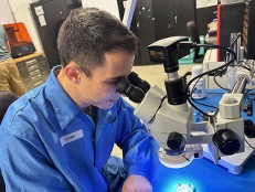 man looking into a microscope