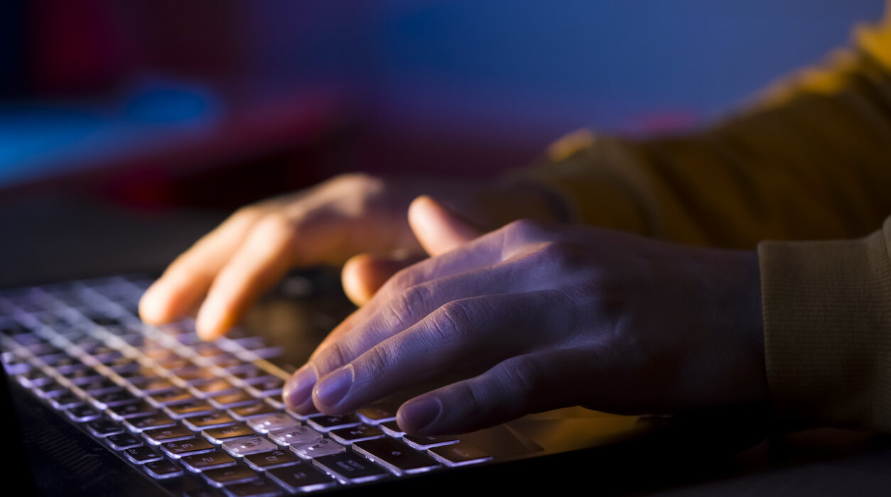 Hands types on a laptop keyboard