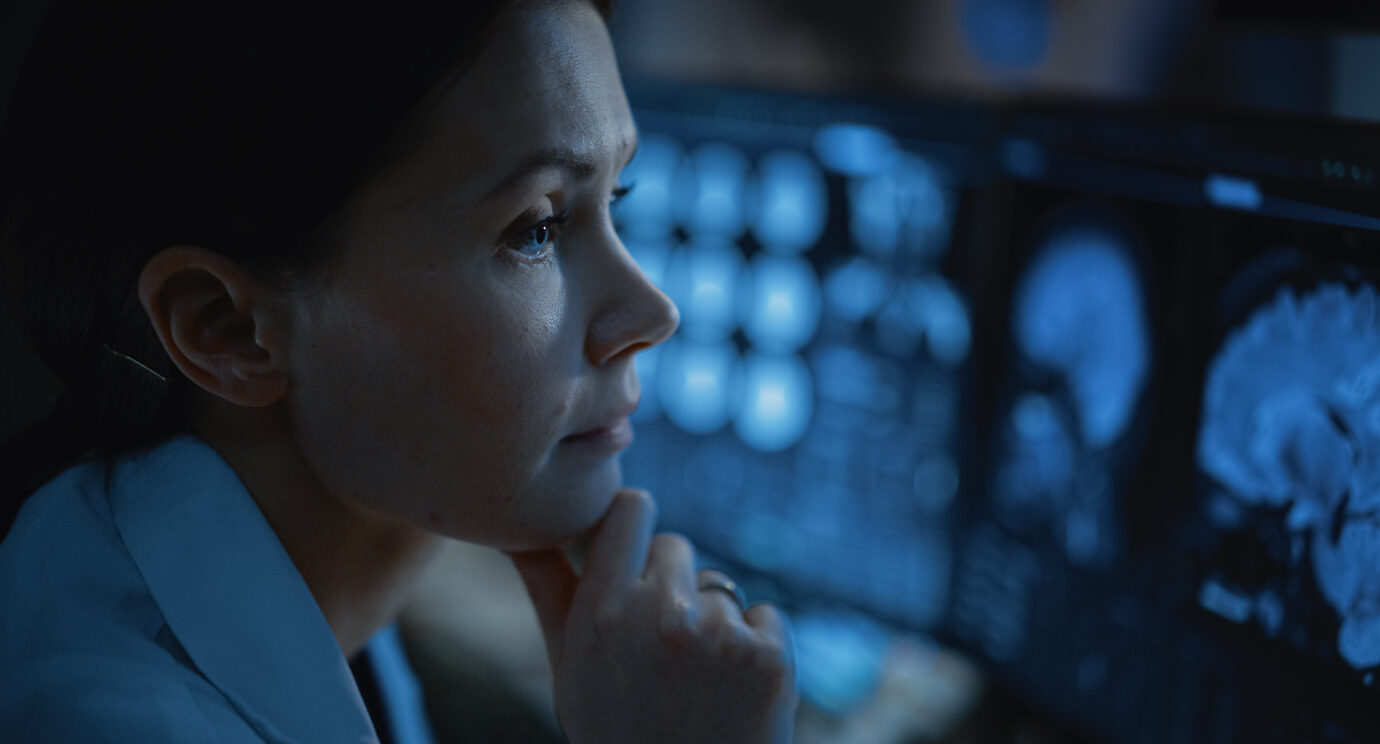 Medical Scientist Using Computer with Brain Scan MRI Images