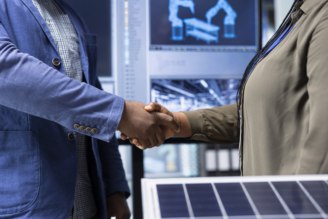 Investor shakes hands with photovoltaics factory manager